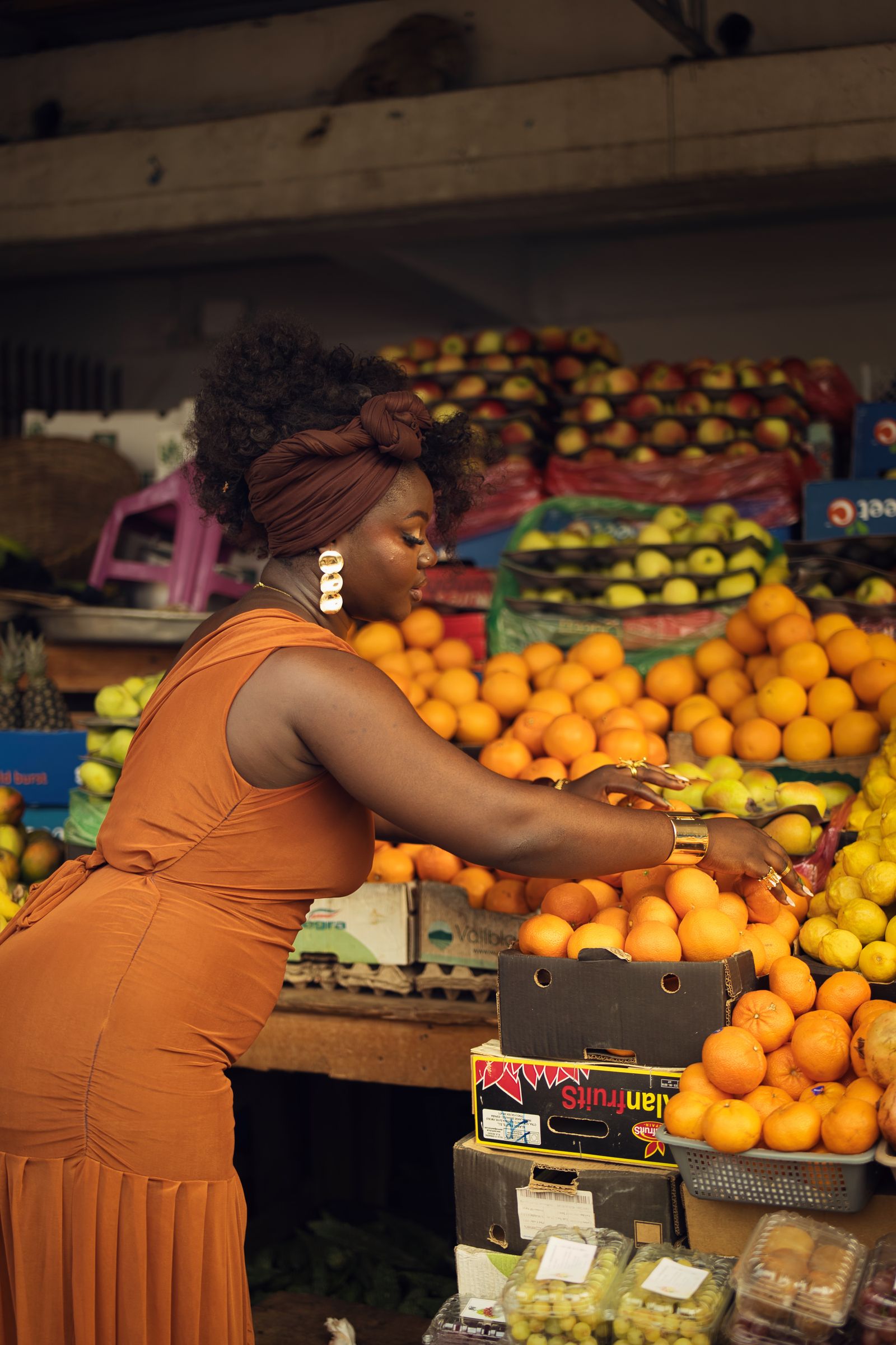 Trader arranging fresh produce at a market stall